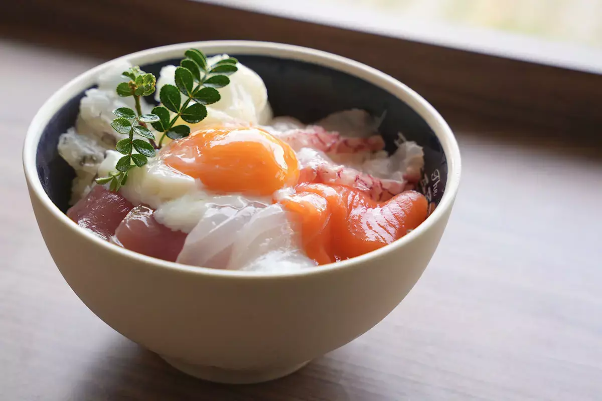 bowl of rice topped with seafood